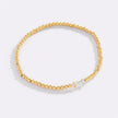 Pulsera de cuentas doradas con piedra natal