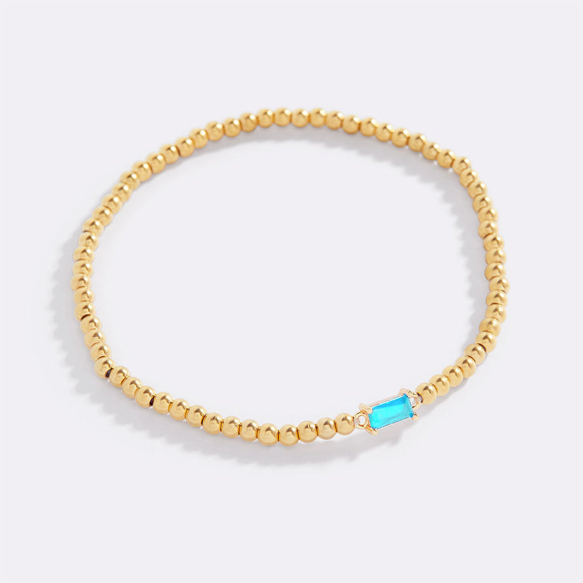 Pulsera de cuentas doradas con piedra natal