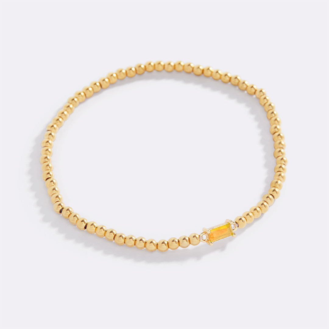 Pulsera de cuentas doradas con piedra natal