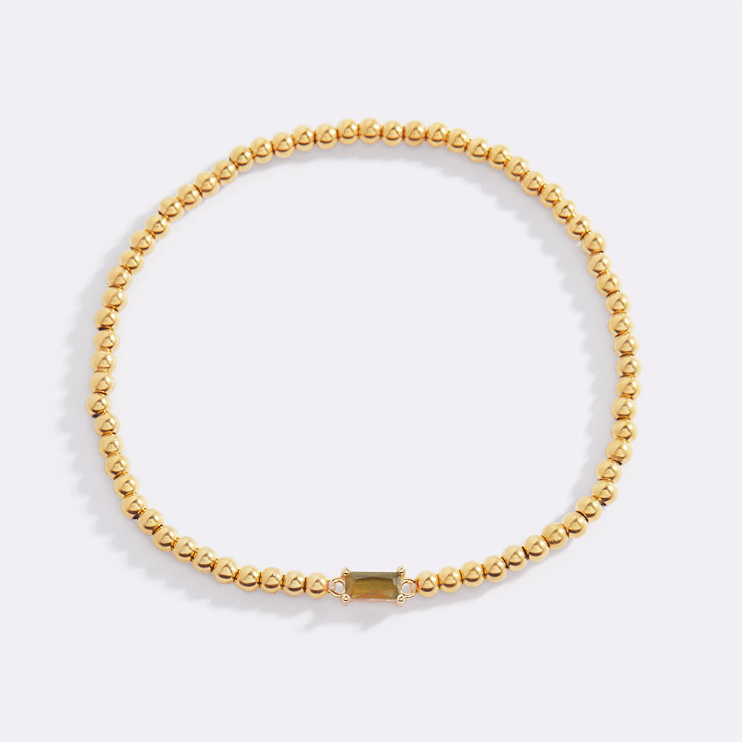 Pulsera de cuentas doradas con piedra natal
