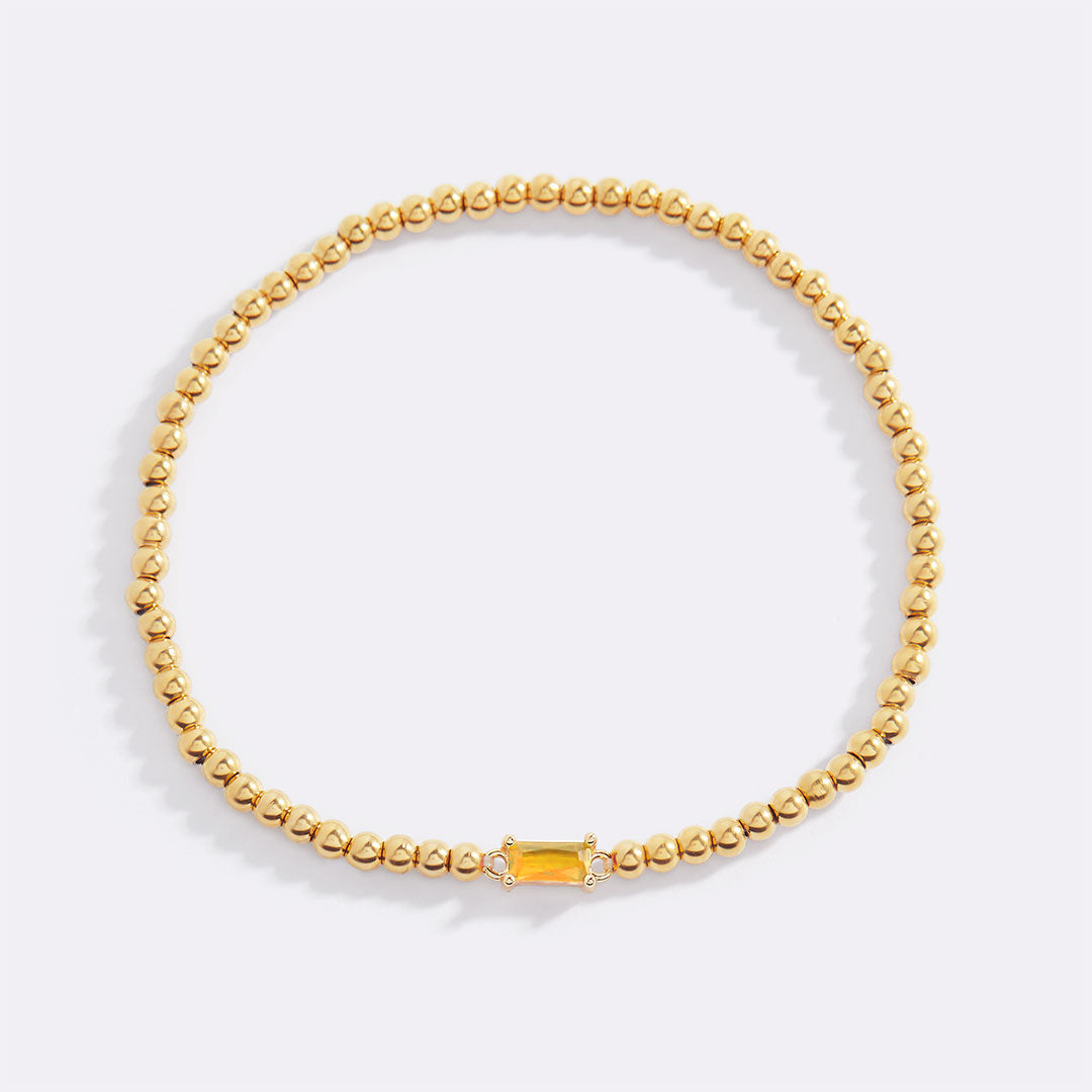 Pulsera de cuentas doradas con piedra natal