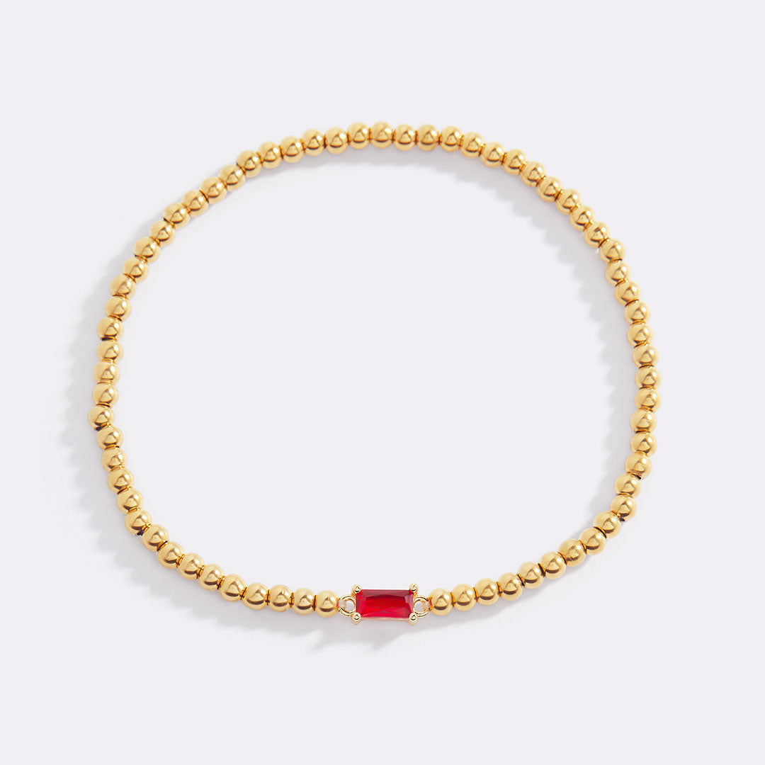 Pulsera de cuentas doradas con piedra natal