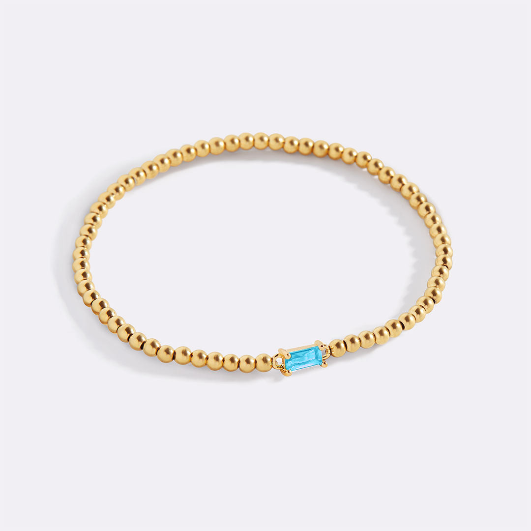 Pulsera de cuentas doradas con piedra natal