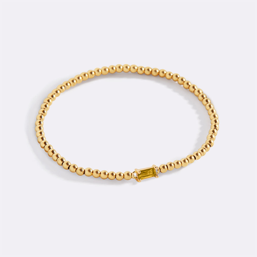 Pulsera de cuentas doradas con piedra natal