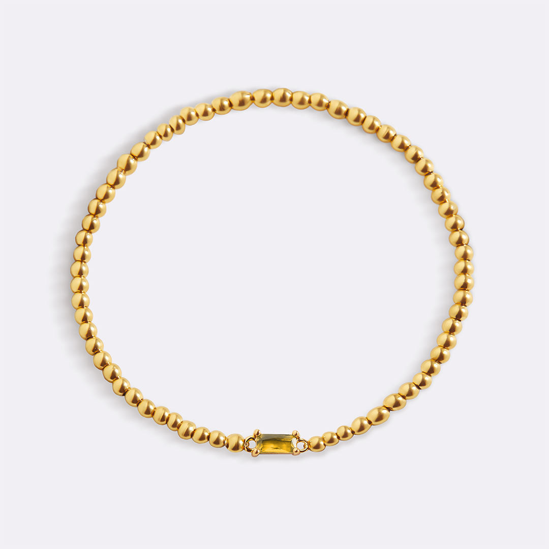 Pulsera de cuentas doradas con piedra natal