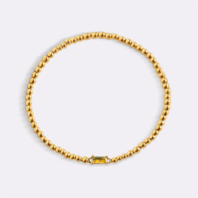 Pulsera de cuentas doradas con piedra natal