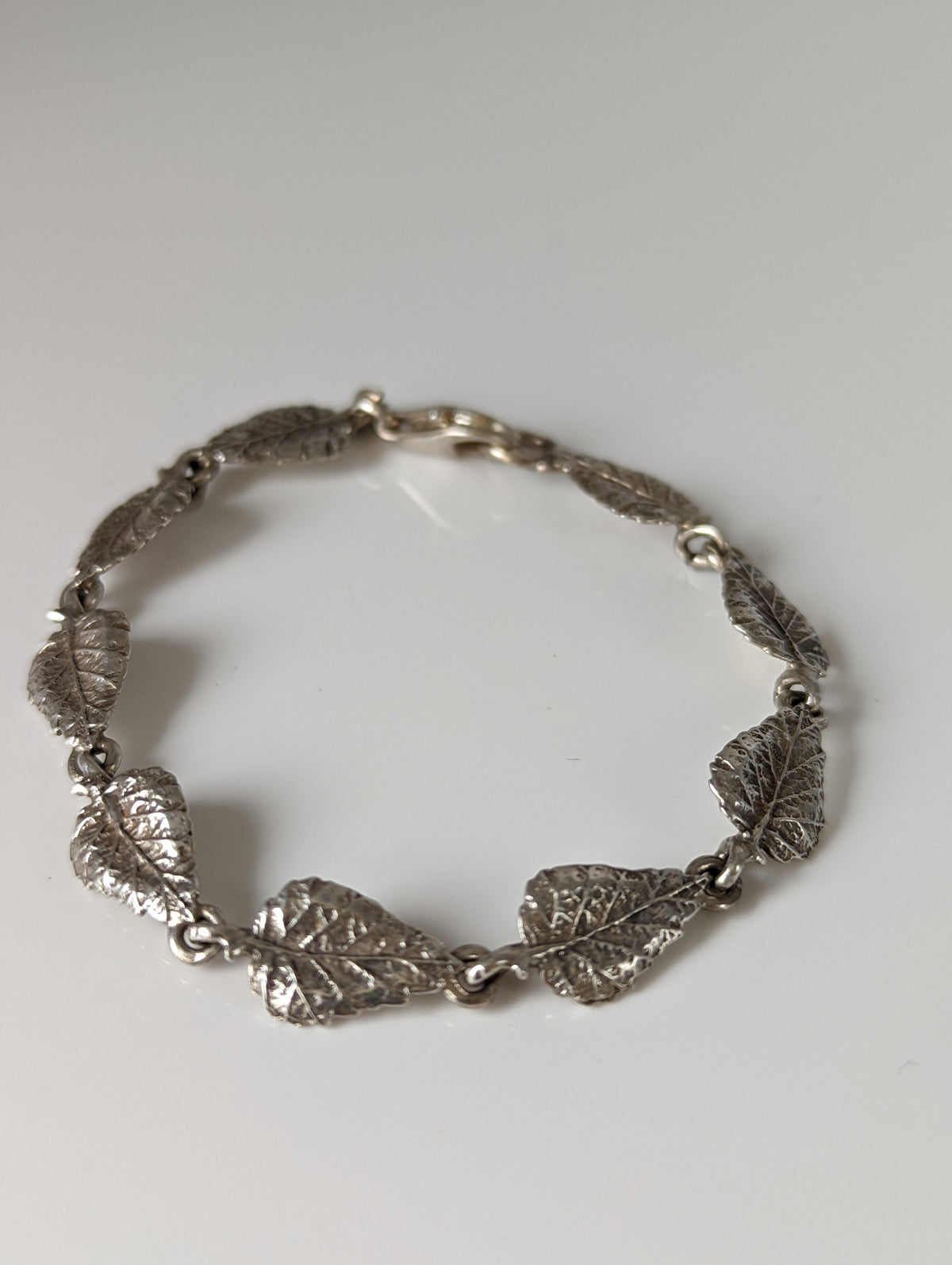 Pulsera de plata con diseño de caballo plateado y hojas detalladas