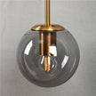 Sizzle Wandlampe mit Glaskugel im Mid-Century-Stil – Bernstein/Rauch/Klar
