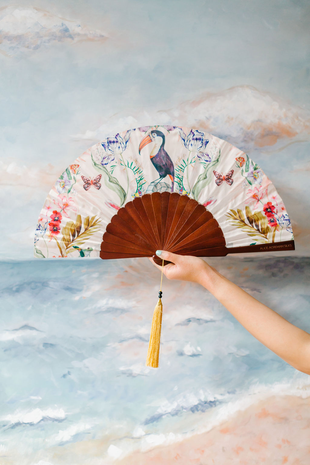 Floral Silk Fan with Toucan design and luxurious Gold tassel, part of the Mysa Collection