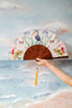 Floral Silk Fan with Toucan design and luxurious Gold tassel, part of the Mysa Collection