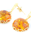 Pendientes colgantes de ámbar con detalle floral dorado
