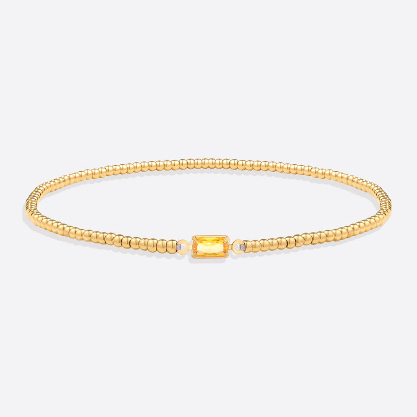 Pulsera de cuentas doradas con piedra natal